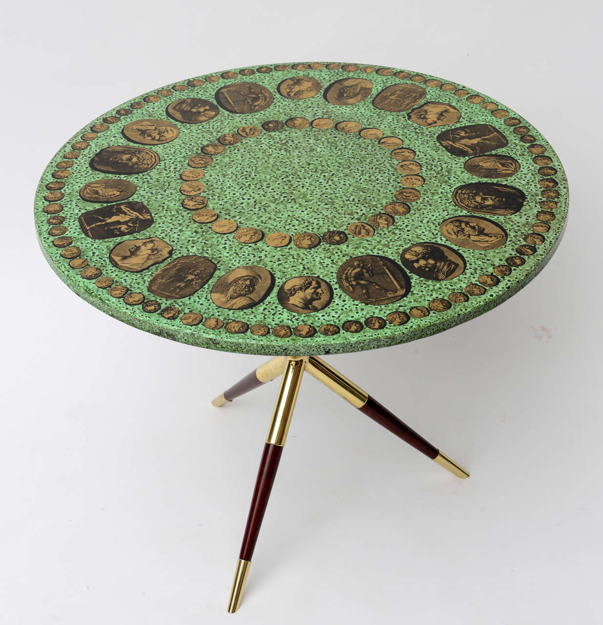 A stellar example of a Fornasetti Classic.
Brass and wood legs 