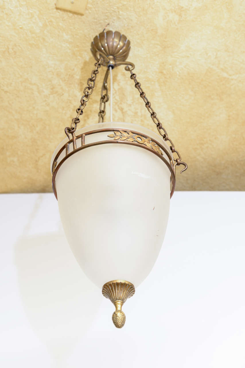 Elegant French frosted glass cone shaped pendant light with flower and leaf bronze fittings. New custom interior fittings are positioned to provide a more even light. Uses 1 - 60 watt max standard Edison base bulb.
29 in H total x 9in Diameter