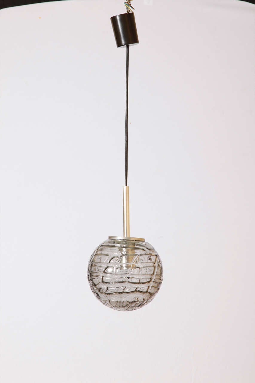 Large to small Doria pendants with grey toned textured glass globes.
Eight pieces available in three sizes available. Measures: diameter/ 2 pc 25 cm / 4 pc 30 cm/ 2 pc 20 cm.
Length of drop rod can be adjusted.