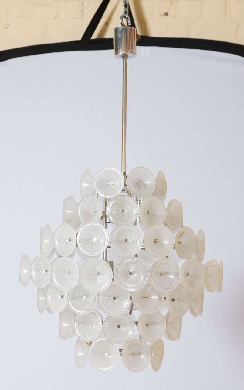 This stunning chandelier features hand blown Murano glass Vistosi disks with nickeled frame and fittings.
Two pieces available.