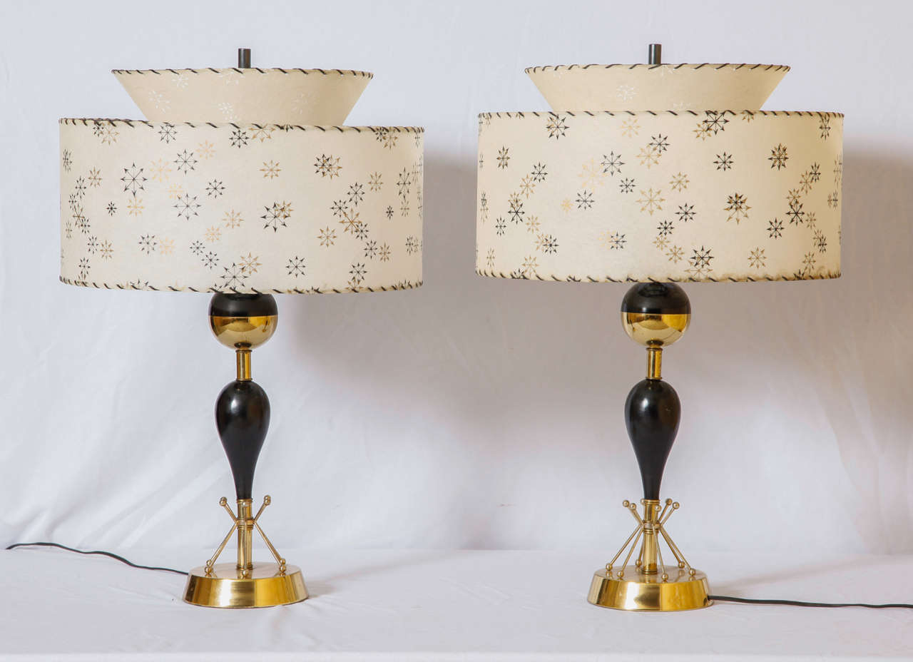 Pair of lamps in brass plated gold and black, lacquered, circa 1960s.
Original shades.