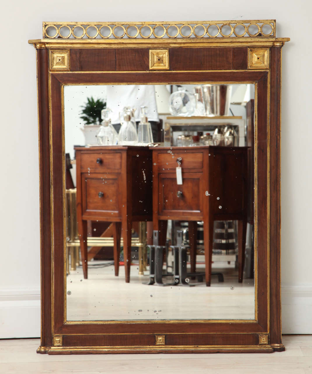 Mahogany and gilt wood mirror with square corner detail, decorative open work ring crown, and original mirror plate