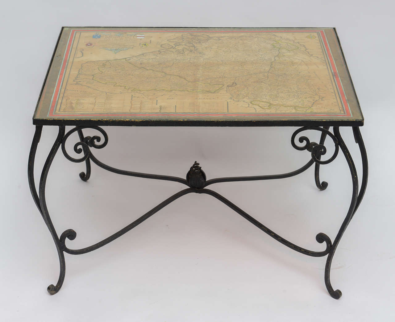 Fantastic little French wrought iron table with antique map of France under glass top. Map is hand colored, dated 1716 and signed by the known French map maker 