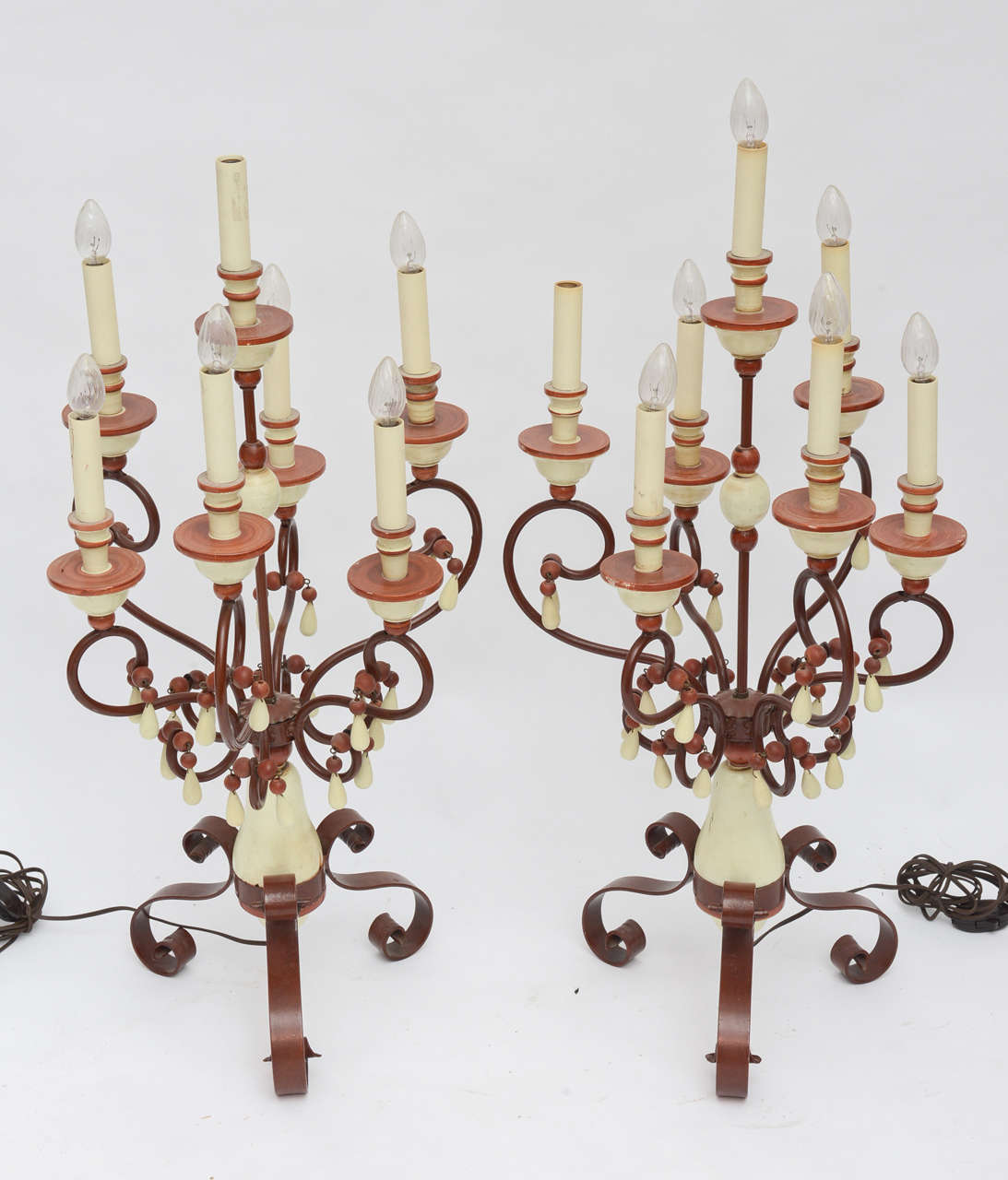 Unusually chic beaded wood and iron candelabra lamps.