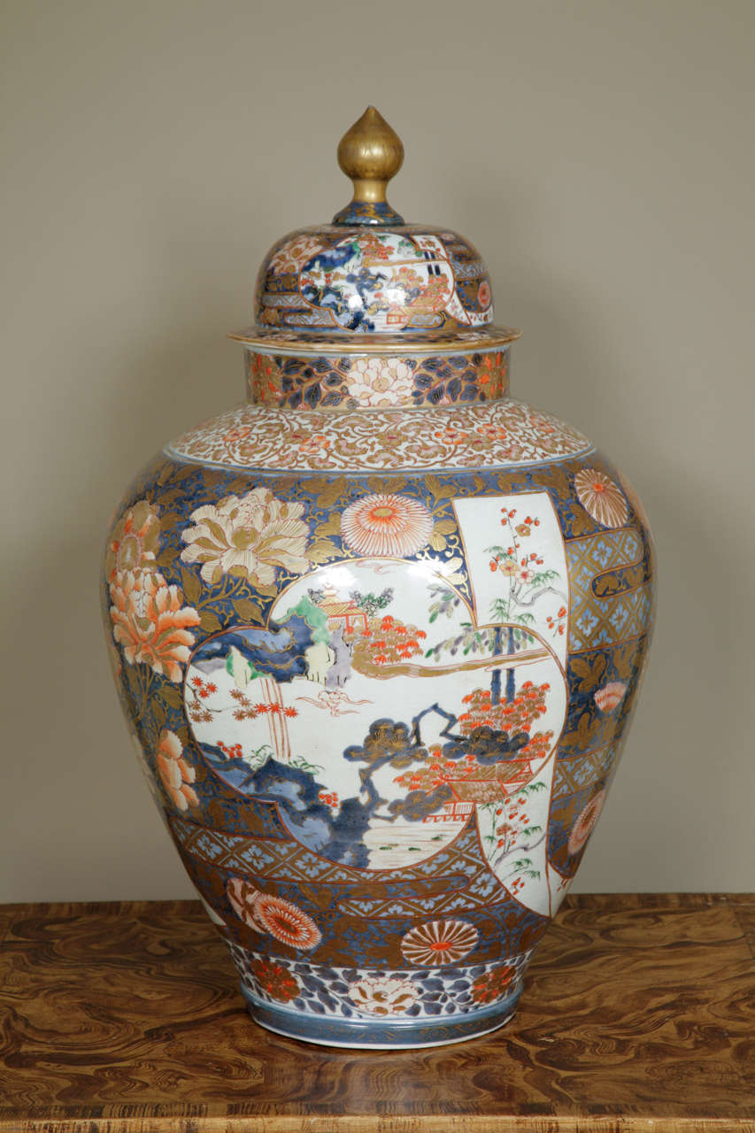 A large Japanese late 17th / early 18th century Imari vase with lid of unusual ovoid form decorated in the Imari palette of underglaze blue (two shades) with overglaze iron-red and green enamel with details in gold. The decoration with scroll and