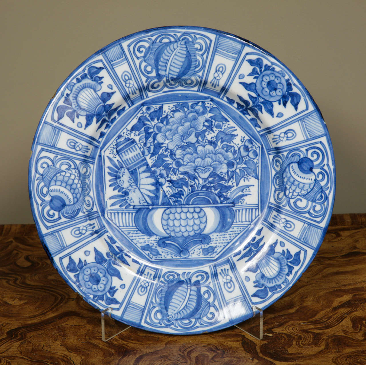 A large early 18th century German Delft style blue & white Kraak style charger. The softer pale blue glaze suggesting possibly Frankfurt. Very well decorated in Kraak motifs showing a bowl containing flowers, a gourd and a scroll central to