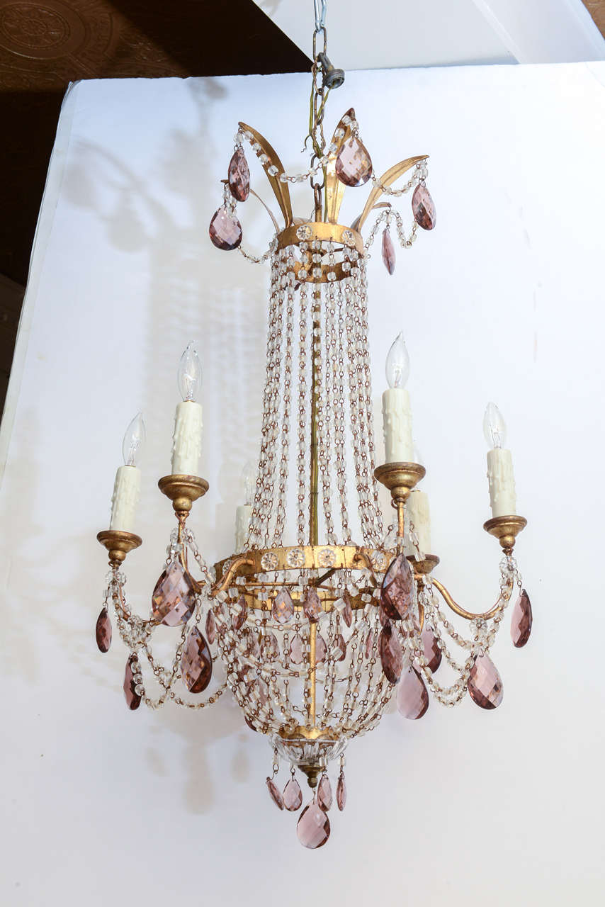 Chandelier, in Empire beaded bag form, having gilded iron frame, six scrolling candlearms, draped in amethyst crystal prisms.