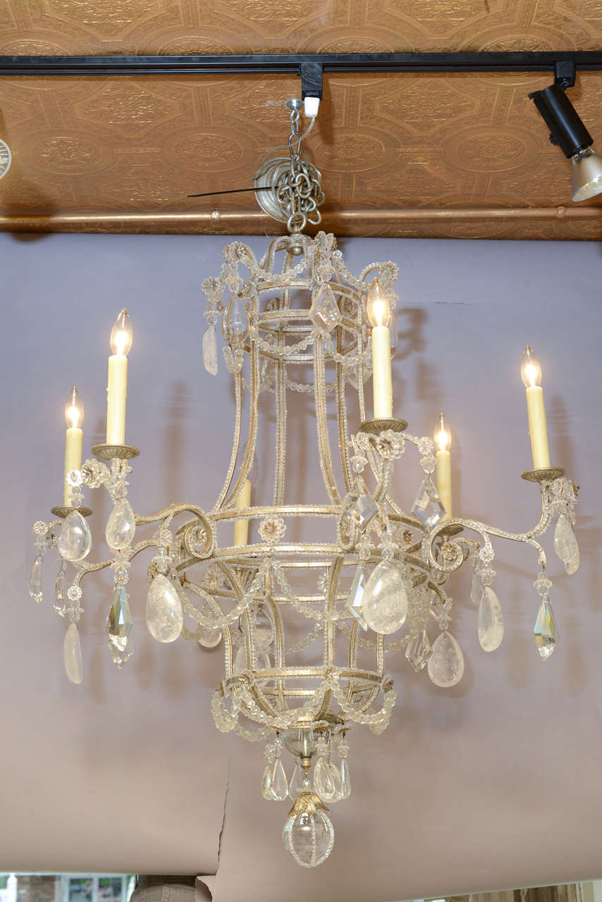 Fine chandelier, in the Italian Maria Theresa style, having a three-tiered silver gilt circular frame entirely outlined in crystal beads, six scrolling candle arms, draped in prisms and rock crystals.

Stock ID: D6808.