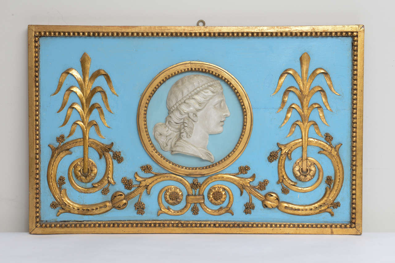 Swedish Gustavian rectangular Relief Carved and Giltwood Panel with a plaster centerpiece  of a woman's profile within foliate scrolls and a gilded border. Adopted for hanging.