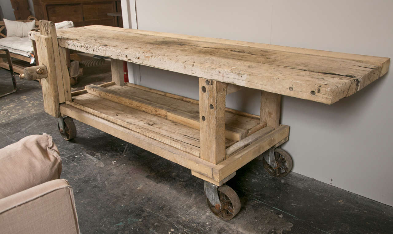 Oak workbench with vice and shelf on steel casters.
