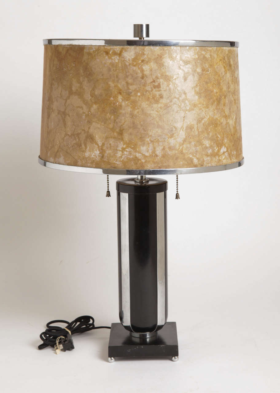 Signed MSLC Model # 3732.

Classic deco form in enameled brass and chromed steel, with ball chromed feet and incised columnar vertical bands..
Rewired in black silk cord, original nickel-plate sockets.

Vintage MICA shade, with original chromed