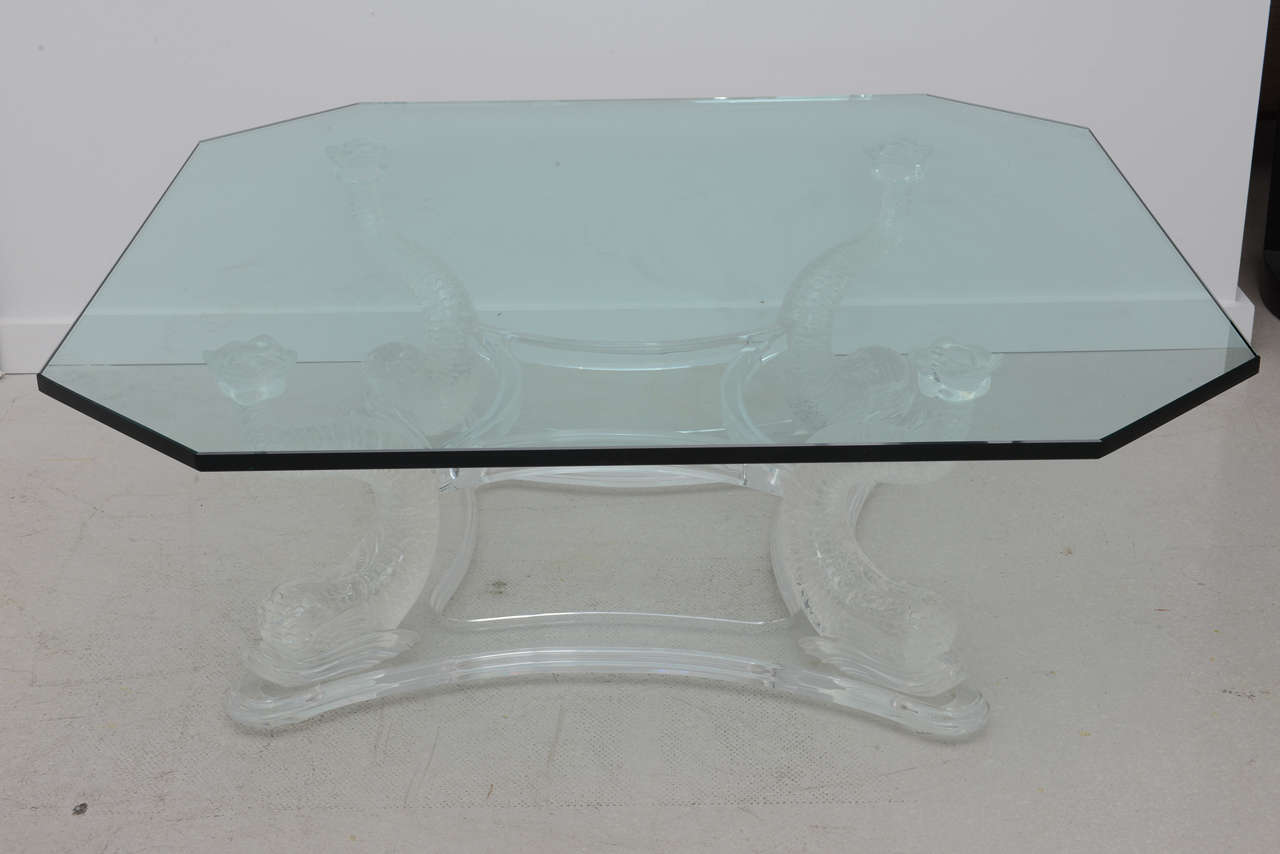 Vintage lucite dolphin table with glass top.