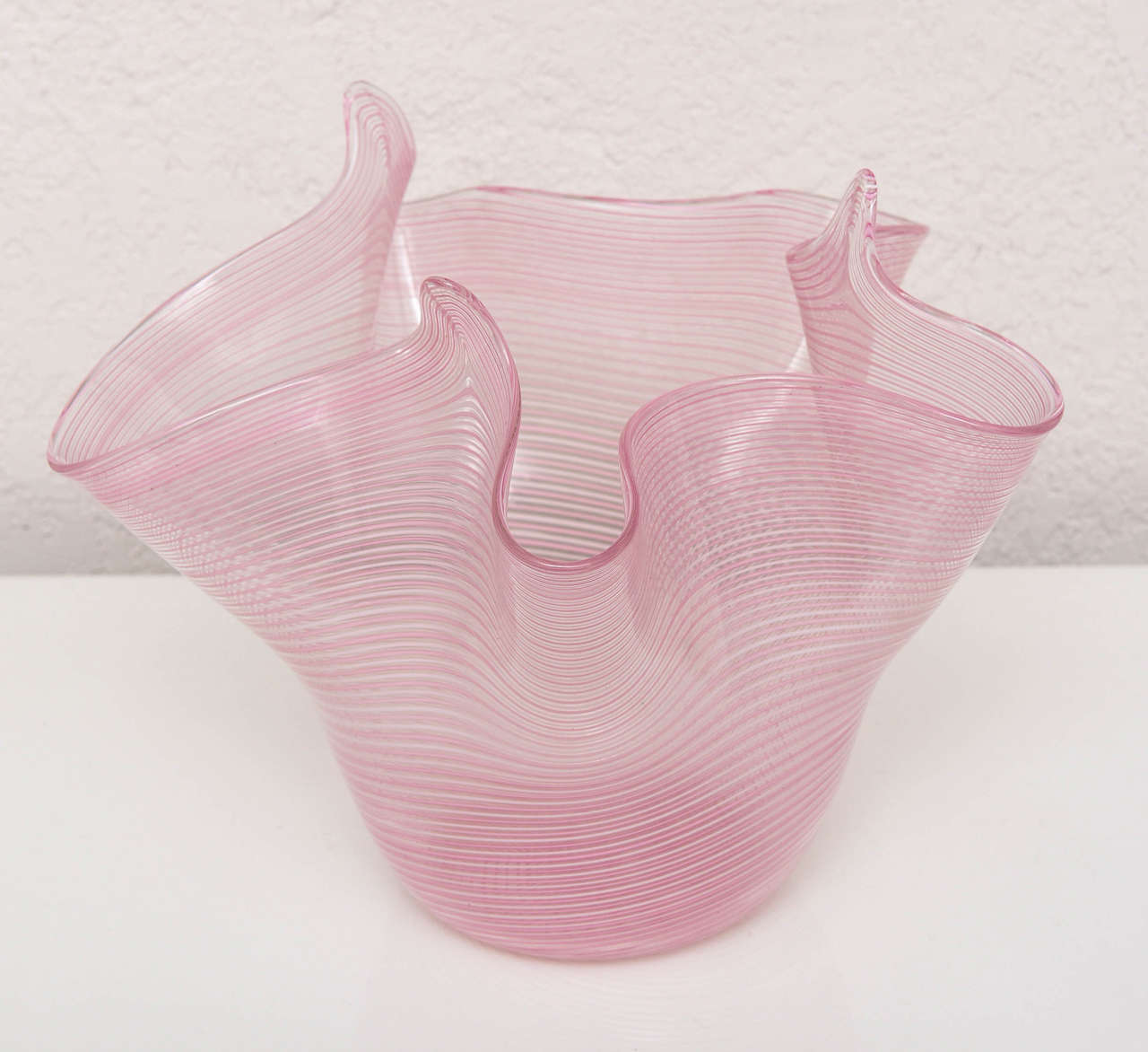 Murano handkerchief bowl or vase with a delicate horizontal stripe pattern of pink, white and clear.

Please feel free to contact us directly for the best price, a shipping quote or any additional information by clicking 