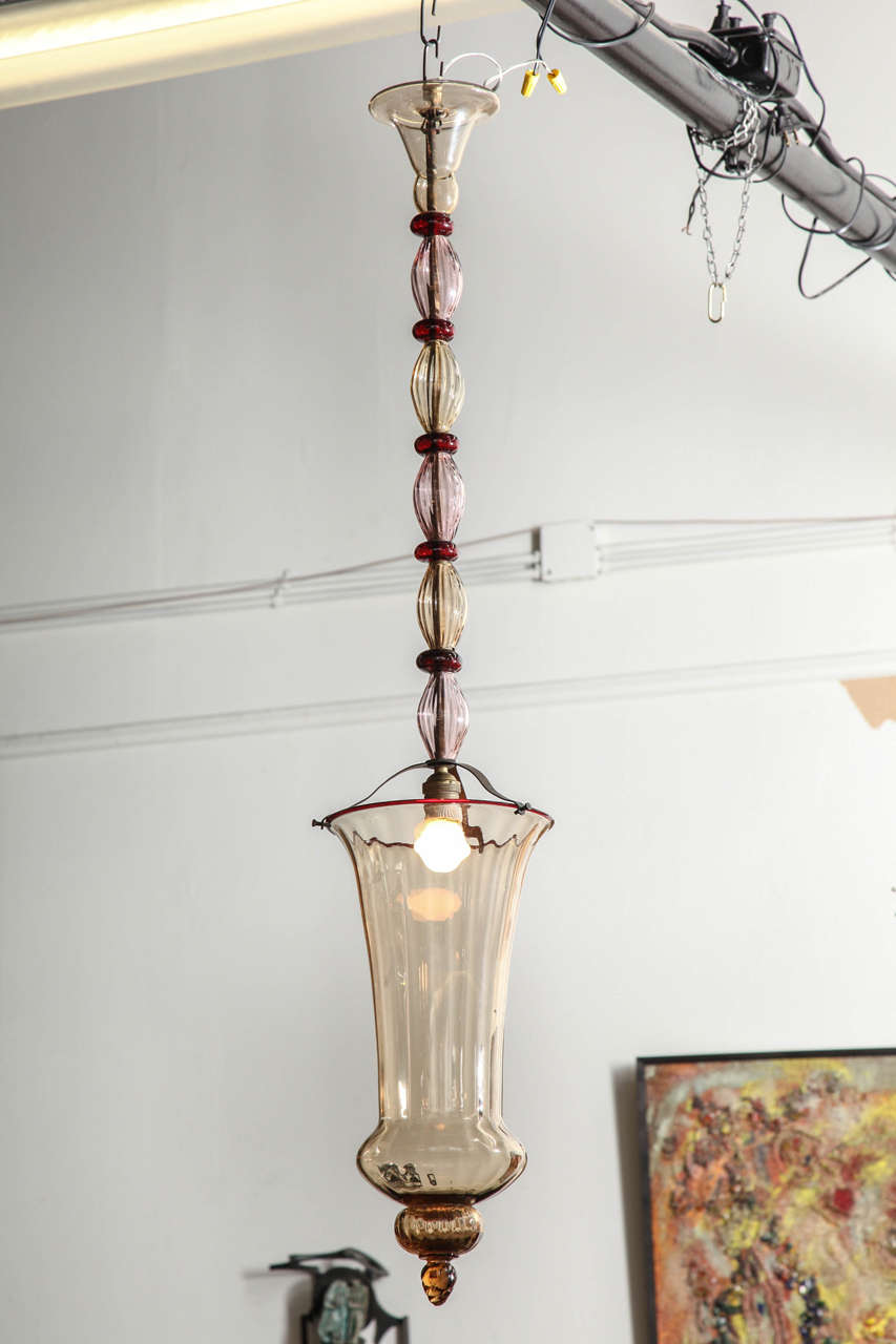 Elegant pendant light made in Venice 1925 by Venini Cappellin designed by artistic director Vittorio Zecchin. Blown in several shades of color, shade in champagne with a red trim, stem with red roundels and lilac ribbed pieces in between. Signed on