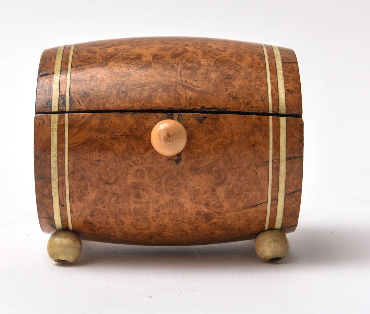 Barrel shaped cigarette holder in burl wood. Spring loaded lid with sliding knob.