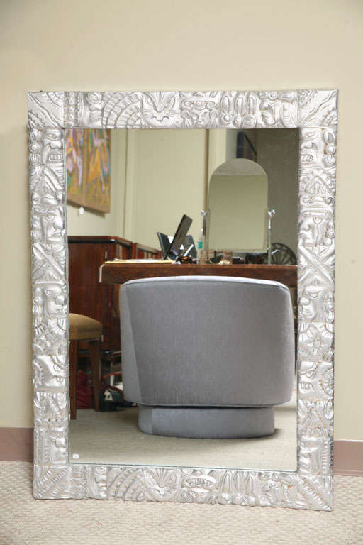 Large silver leaf framed mirror. The carving is in the style of Mexicanwork. Interesting and beautiful.