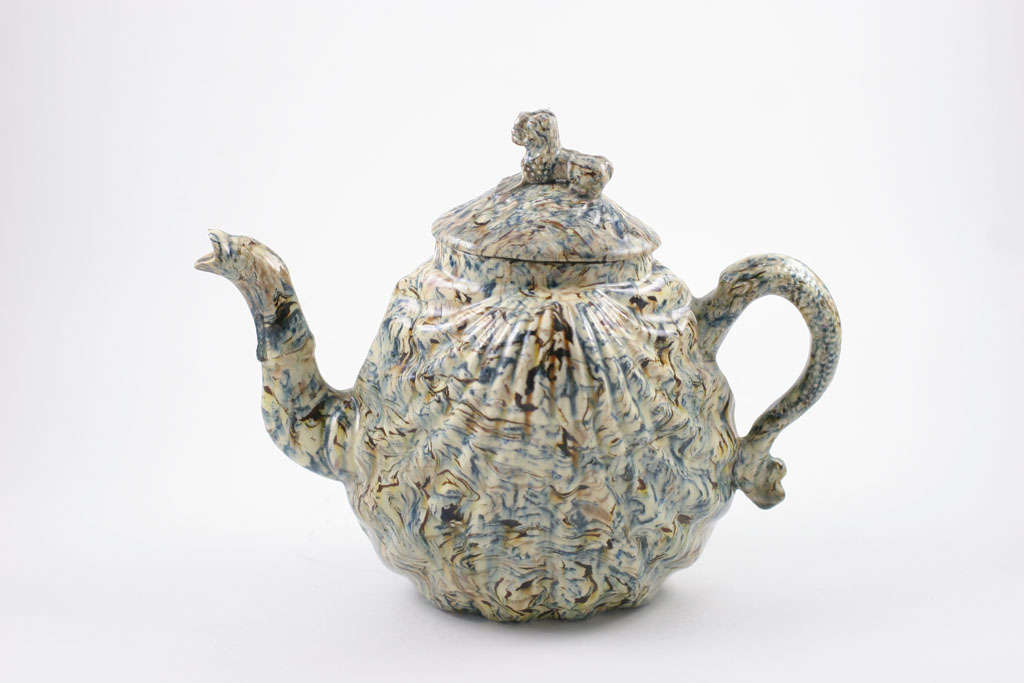 A fine English solid agate pottery pectin shell molded teapot with serpent spout and Oriental lion finial