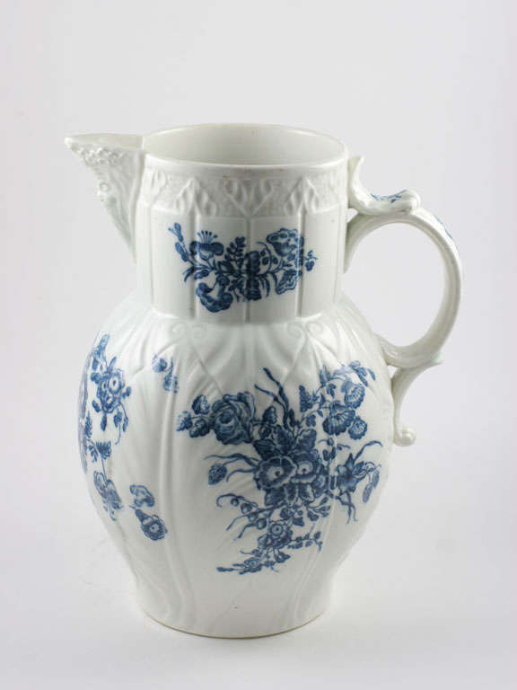 A fine Caughley blue and white porcelain mask pitcher transfer printed in a floral design, underglaze blue S