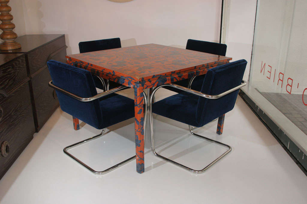 Game table wrapped in persimmon and cobalt Chinese motif fabric.<br />
With four cantilevered blue mohair velvet chairs in tubular steel.