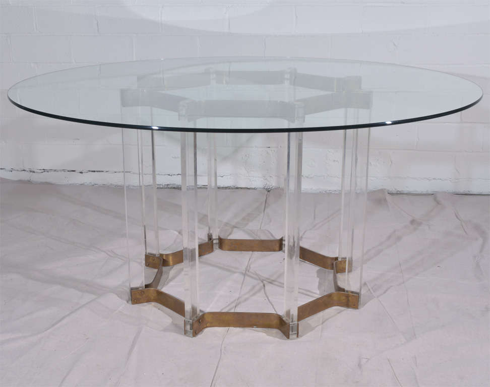 Modern lucite and brass-base dining table with glass top. Base measures 33