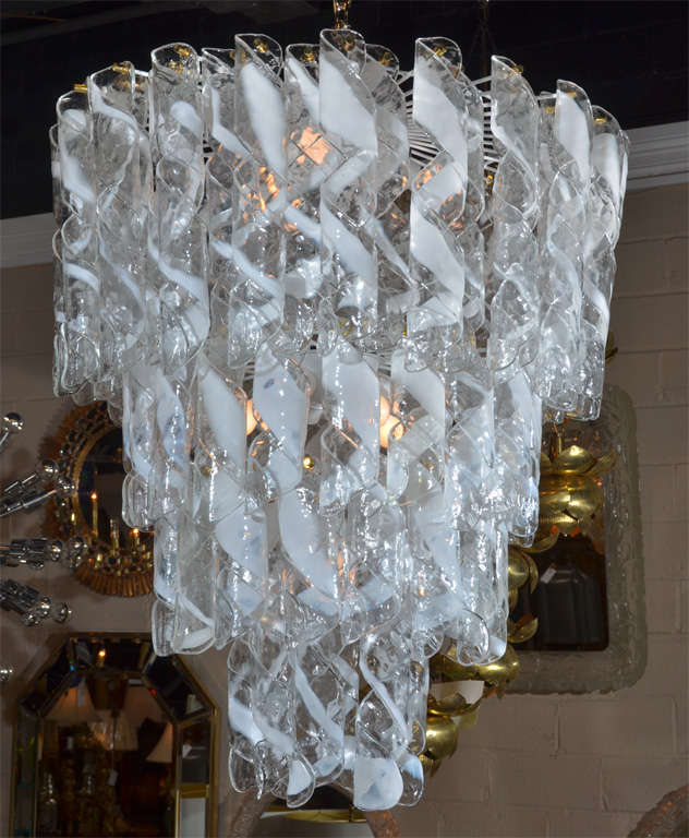 A huge and impressive hand made swirled glass Italian Mazzega chandelier. All glass pieces are in prefect condition each secured by brass fittings. Steel frame has been refurbished in white and newly rewired.