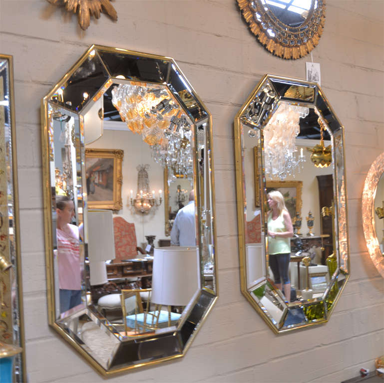 Pair of brass framed beveled wall mirrors made in Italy.