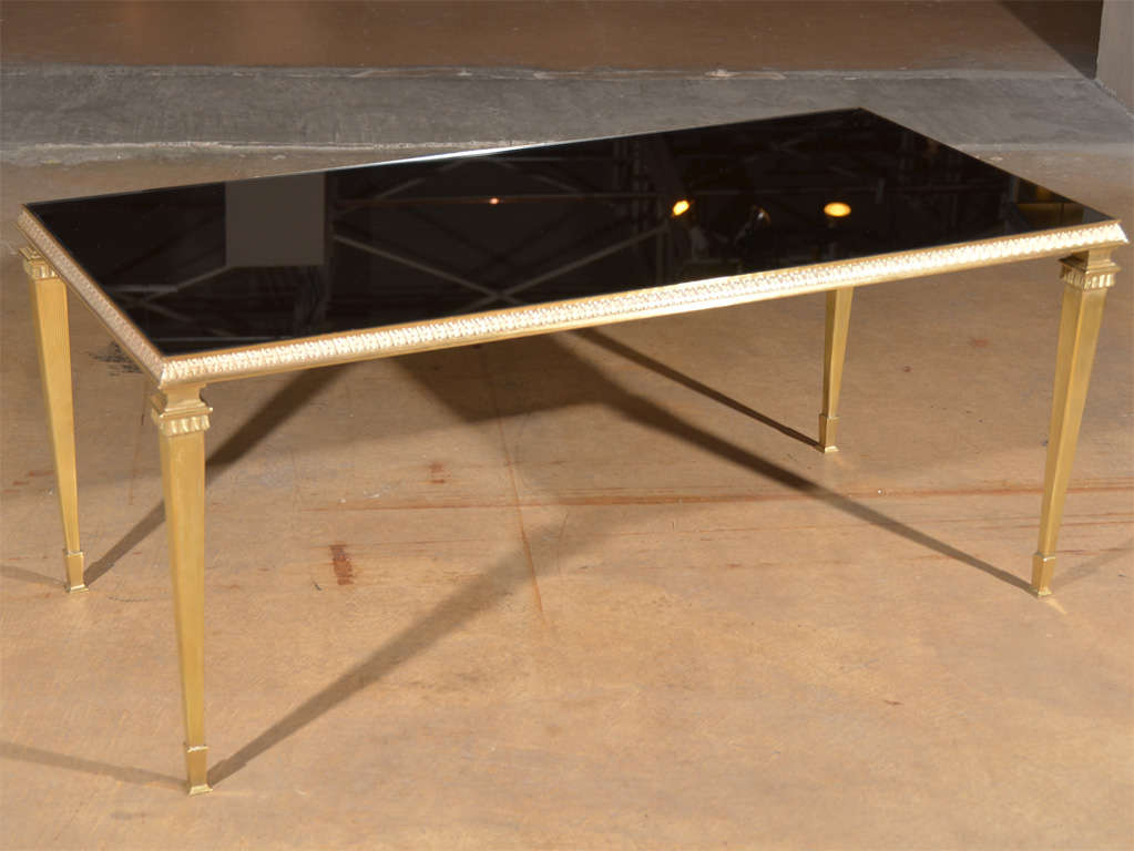 French bronze neoclassic cocktail table with inset dark mirrored glass top.