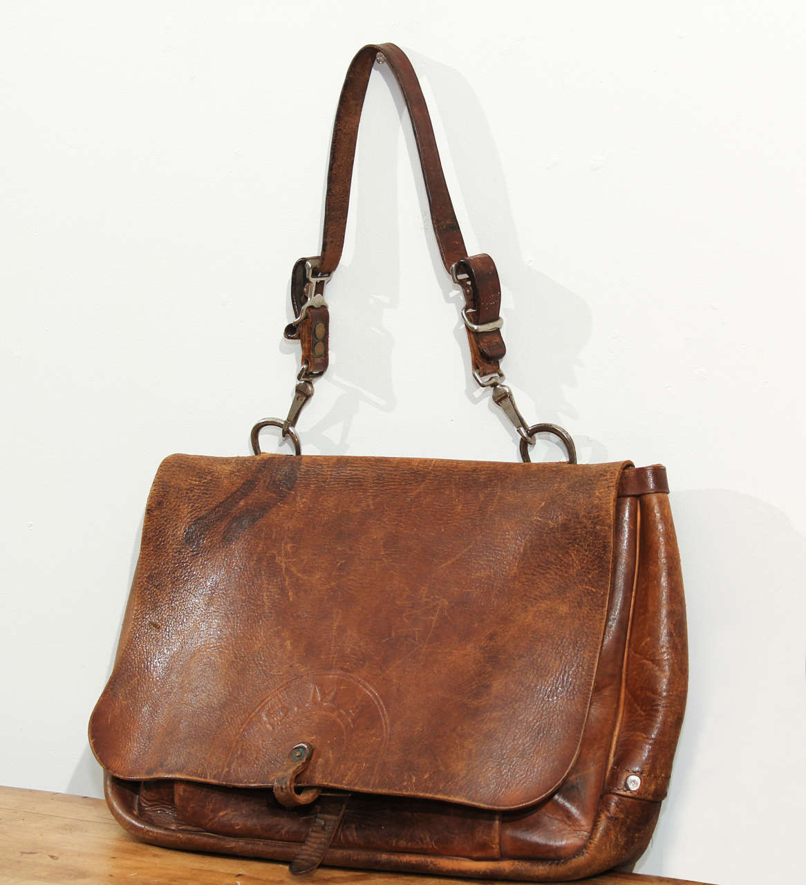 Vintage Bucheimer Mfg. cowhide mail bag with US Mail embossed on the flap.   Well-worn patina with chromed metal hardware.