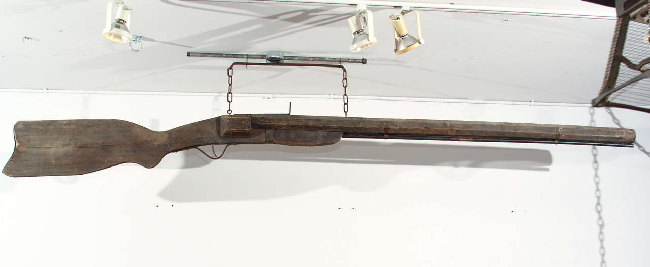 Giant carved wood shotgun with iron sight, trigger and trigger guard, originally used as a trade sign for a Texas gun and ammunition shop.