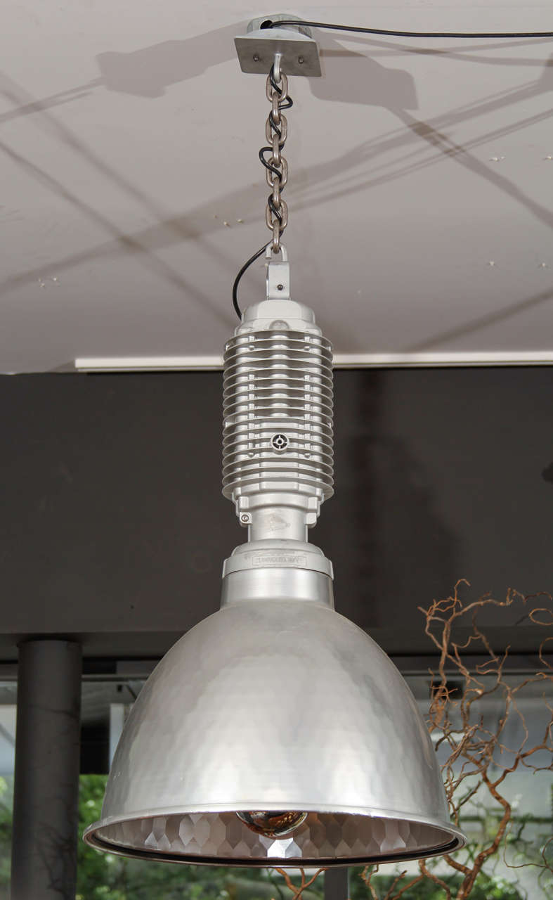 These large industrial pendants have been reworked for residential use with custom socket assemblies, custom canopies and adjustable drop lengths.  The reflector interiors have a slight honeycomb texture to them, providing an unusually soft light.  