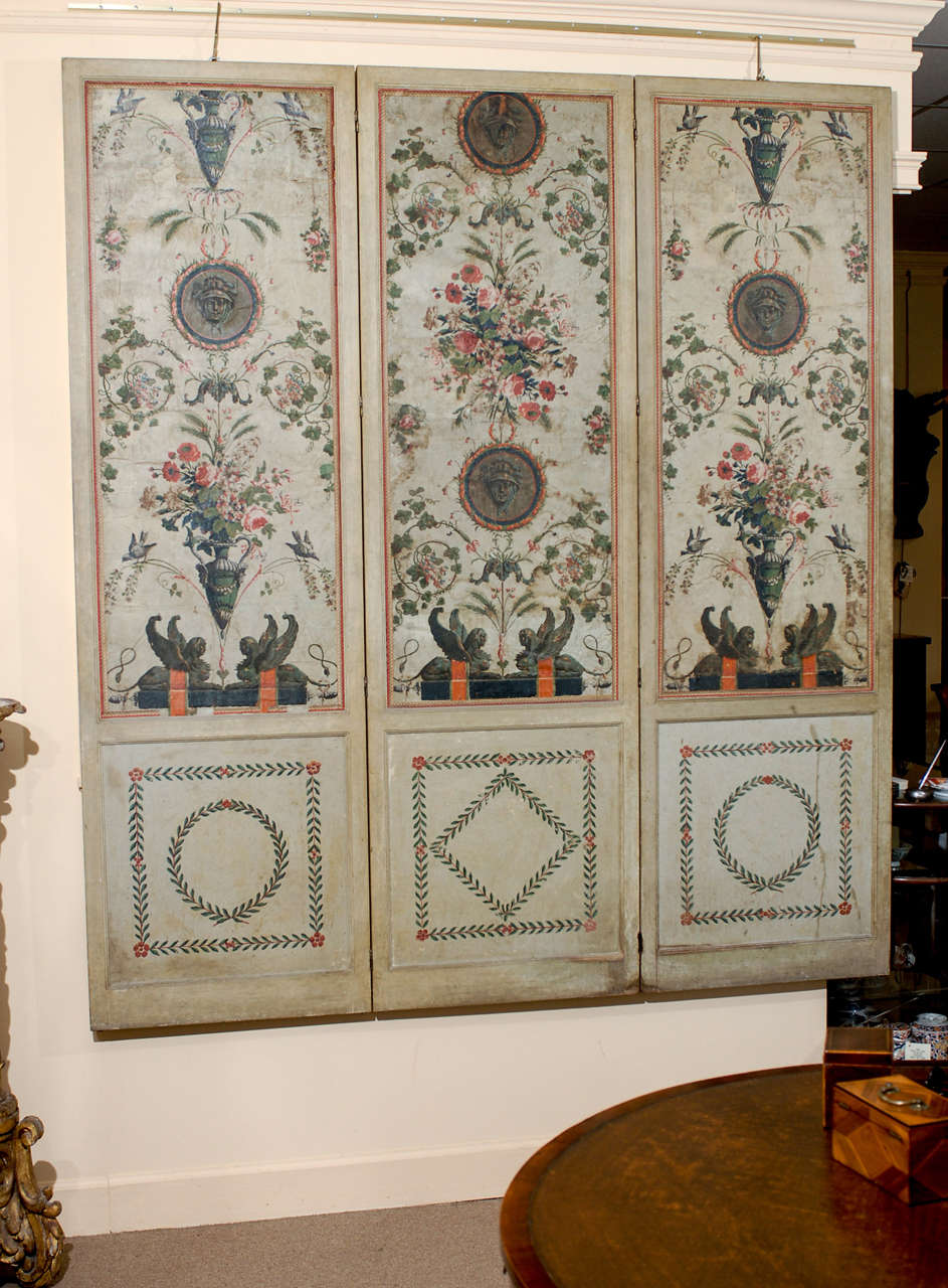 A three panel French wallpaper folding screen in the Neoclassical style with foliage and sphinx detail. 