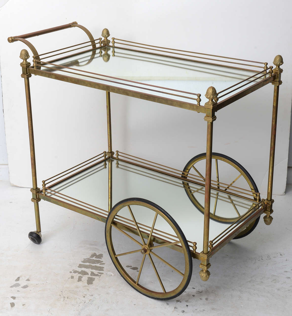 Brass serving/bar cart with mirrored shelves.  Original patina on brass.

Please feel free to contact us directly for a shipping quote or any additional information by clicking 