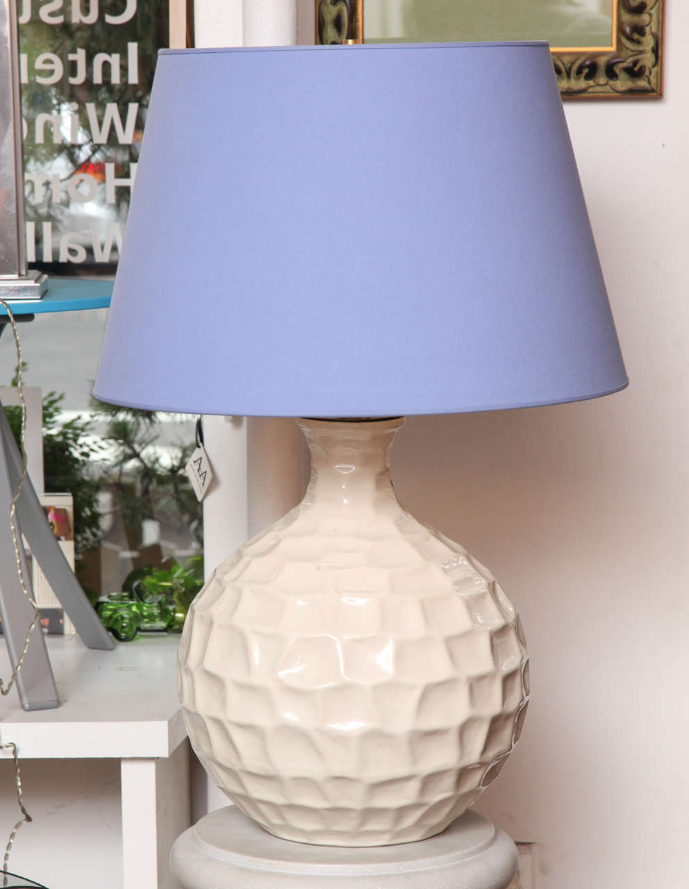 These cream porcelain table lamps are very chic and classy. They were updated with their contemporary purple linen shades. The shades are paper inside and linen outside. The shades measure 15.13