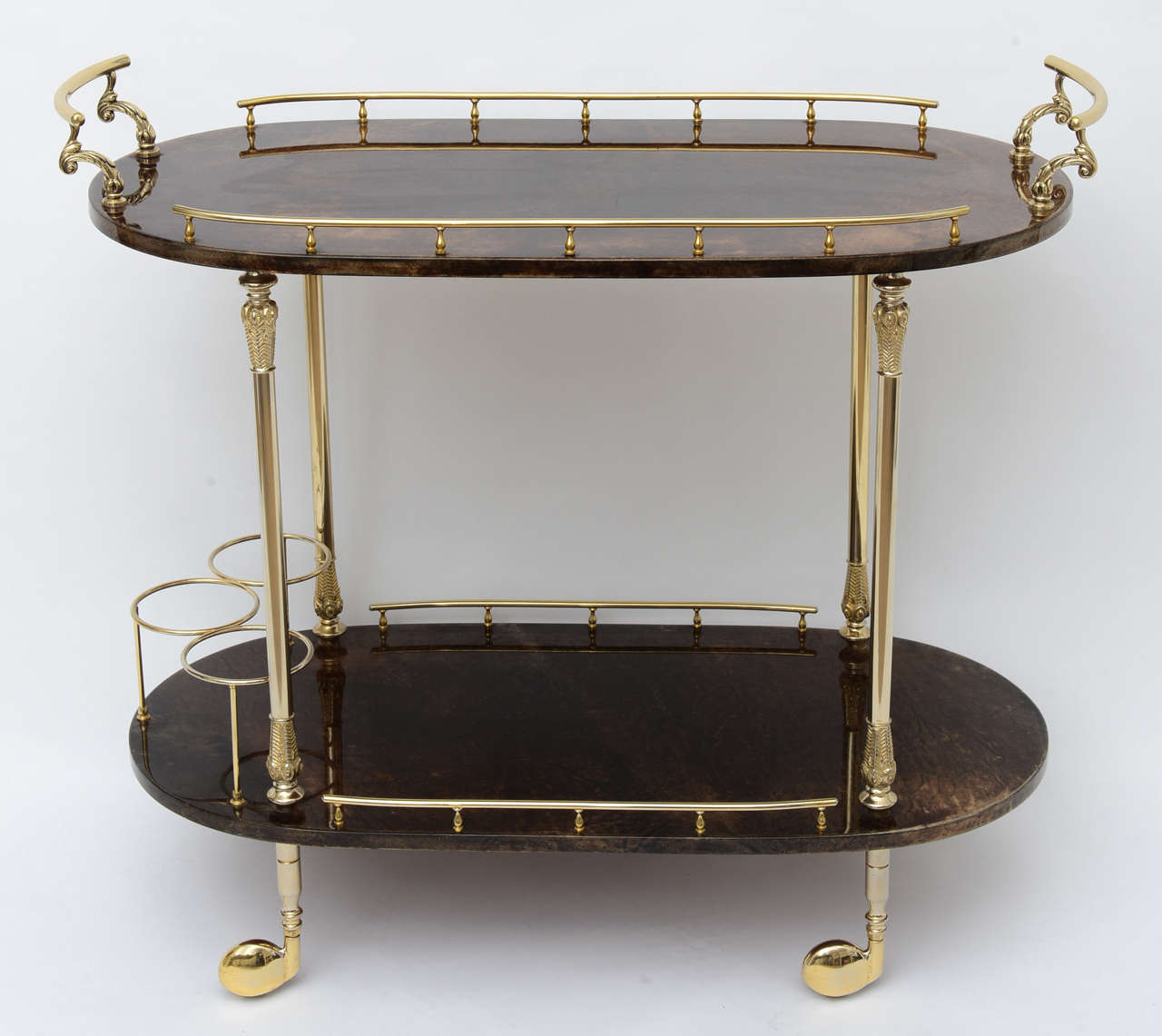 Stunning two tier bar cart wrapped in goatskin and covered with clear coat lacquer. The brass has been professionally polished and the golf club covered wheels roll perfectly. This piece is signed with the original Tura sticker.