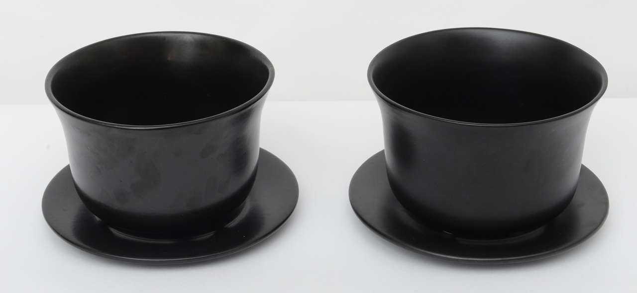 Pair of matte black orchid pots with saucers, signed Elsa Peretti for Tiffany. One is Italian and one is made in USA. Sold as apair.