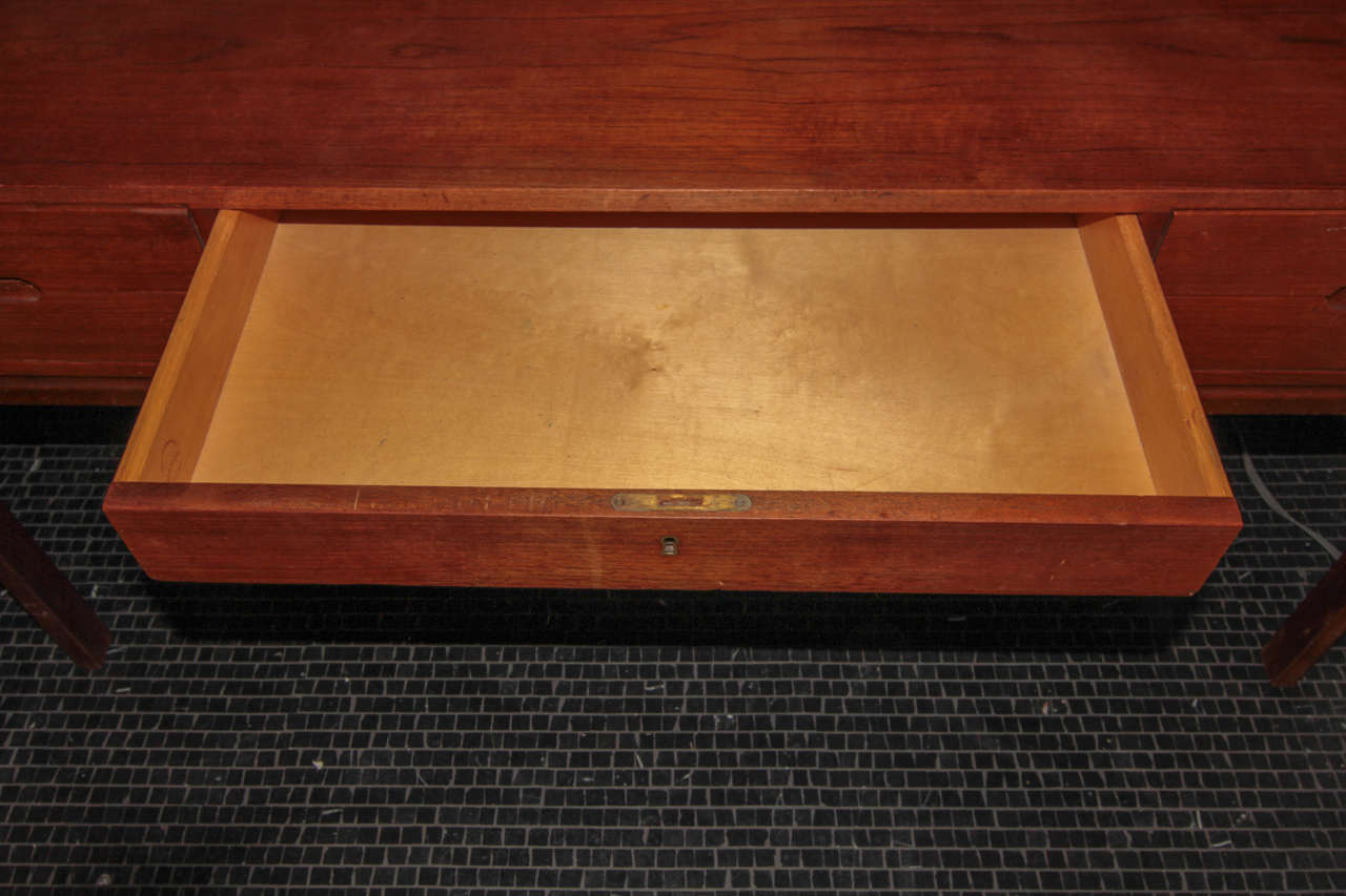 Rare mid century modern teak desk by Arne Wahl Iversen for Vinde Mobelfabrik. 4 drawers with mirror facing handles, center drawer and back storage-1960′s.