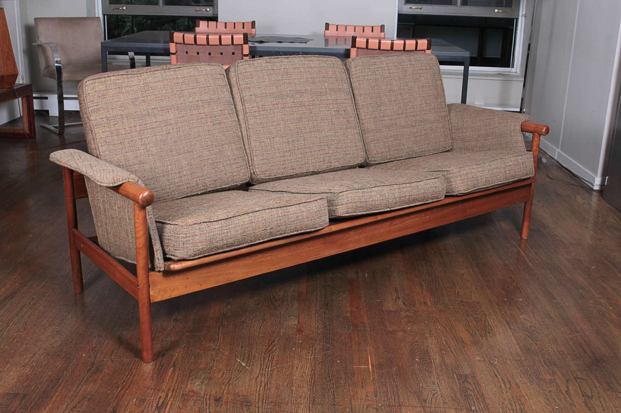Three seat Danish sofa with solid sculptural teak frame and original cushions-1960′s.