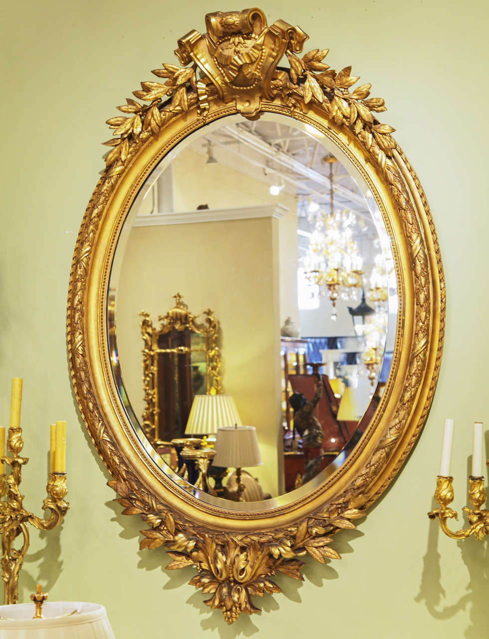 19th c Beautifully carved and gilt oval mirror. Cartouche design at top with beautiful leaf design