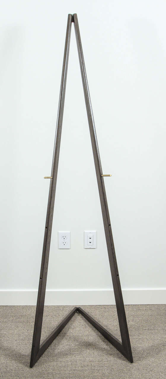 Cruz easel by Lawson-Fenning. Available in light or dark oak with adjustable height brass dowels.