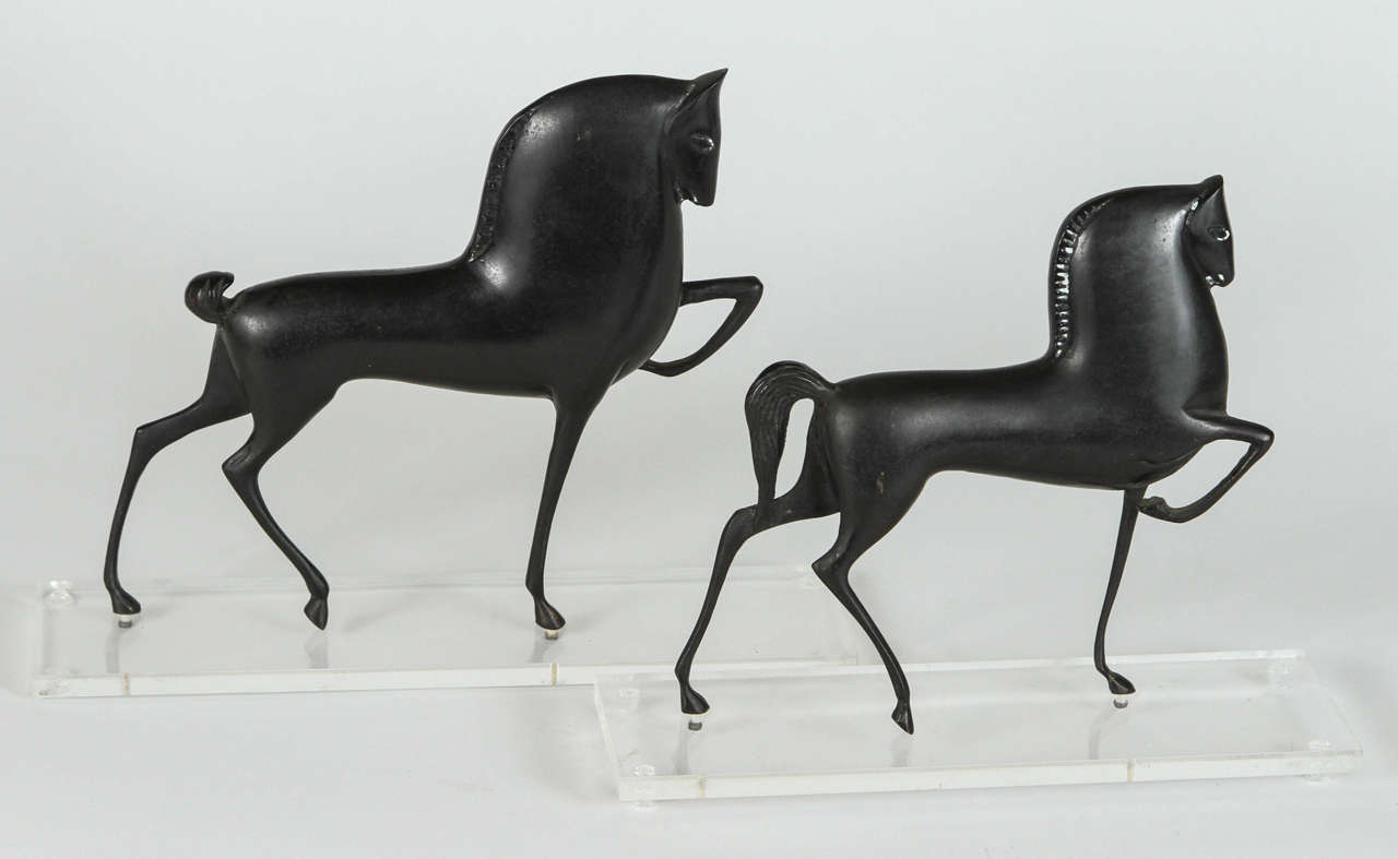 Pair of Art Deco style bronze horse sculptures on Lucite bases.