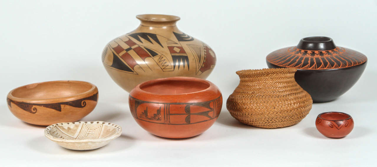 Collection of Native American pottery and woven vessels. Pottery is hand thrown and painted with slip glazes in a traditional design of 19th century. Small vessel is a woven reed basket. Priced as a group.

1- 9 x 6.5