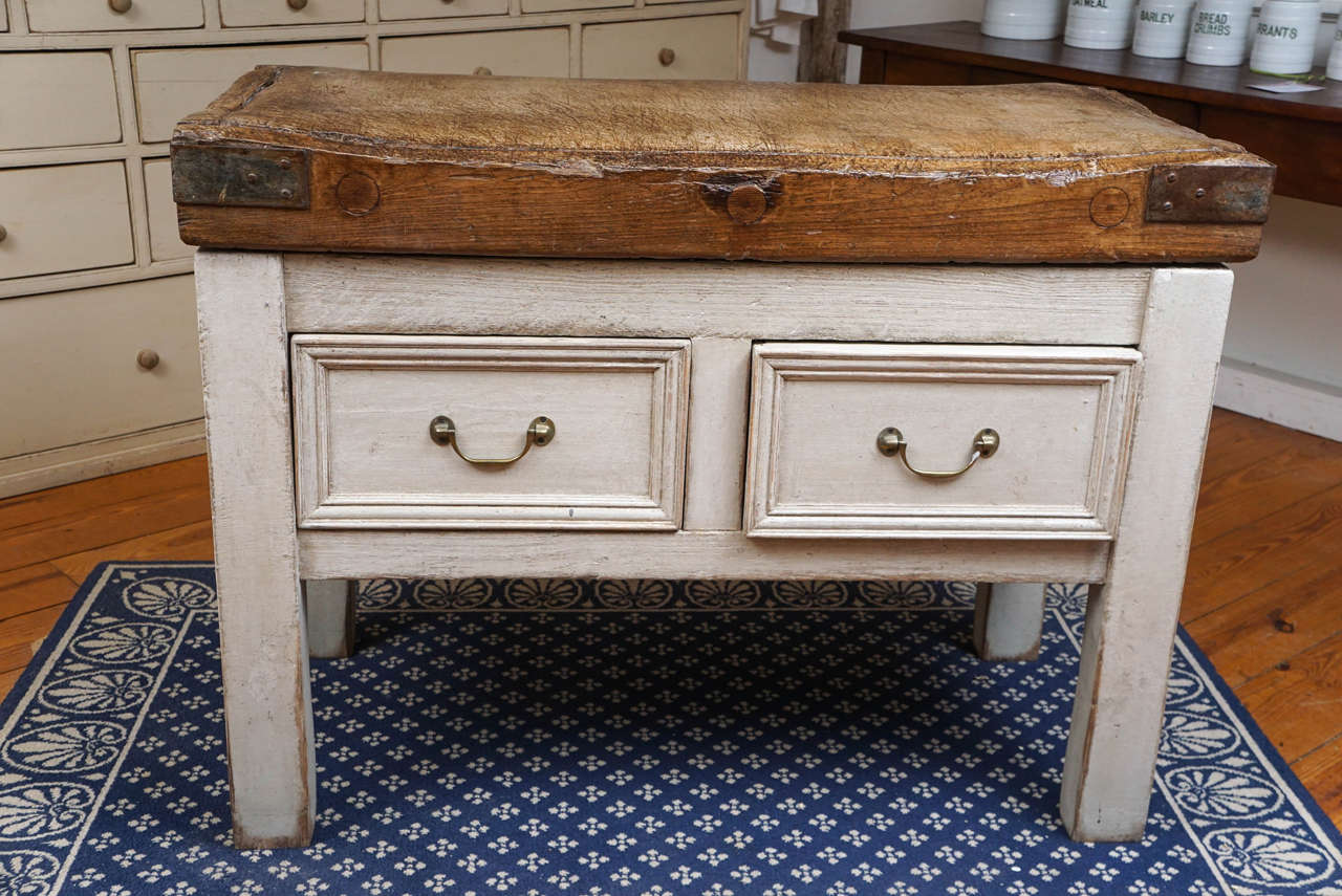 The butcher block top on this piece is as stunning and original as any butcher block we have ever purchased. The base was built to fit from old wood and the two drawers go both ways from front to back. This would make a perfect center island in a
