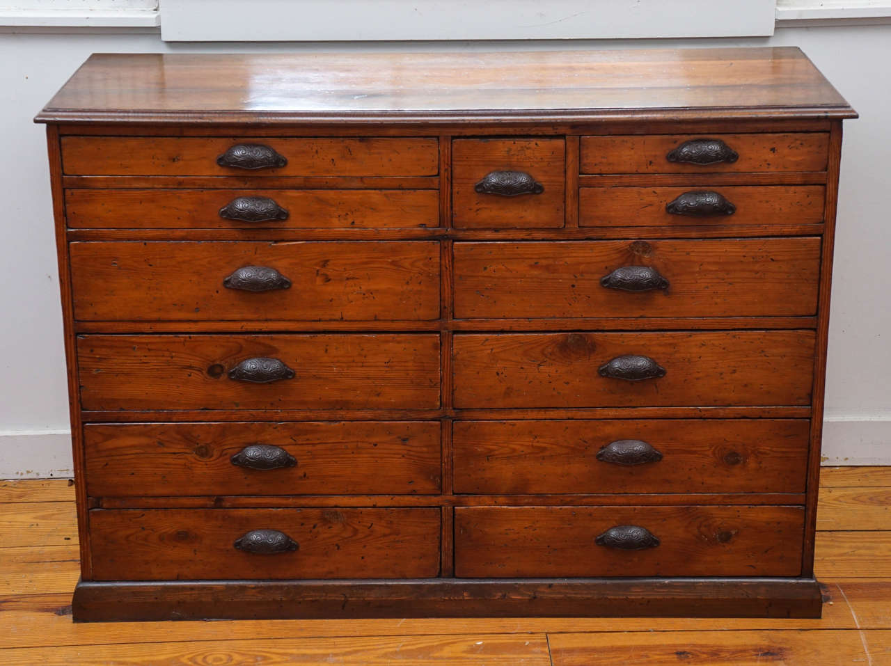This English bank of drawers has its most unique attribute when you open some of the drawers which have partitions. The patina is very, very rich and the hardware is original. We love multi drawer pieces at Painted Porch.