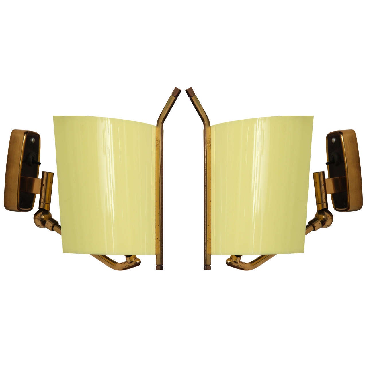 Pair of modernist sconces made in 1955 in Milan by Stilnovo.
Soft yellow plexiglas shades with brass adjustable swing arms.
Great as bedside. Sconces signed on bar and back plate.
   