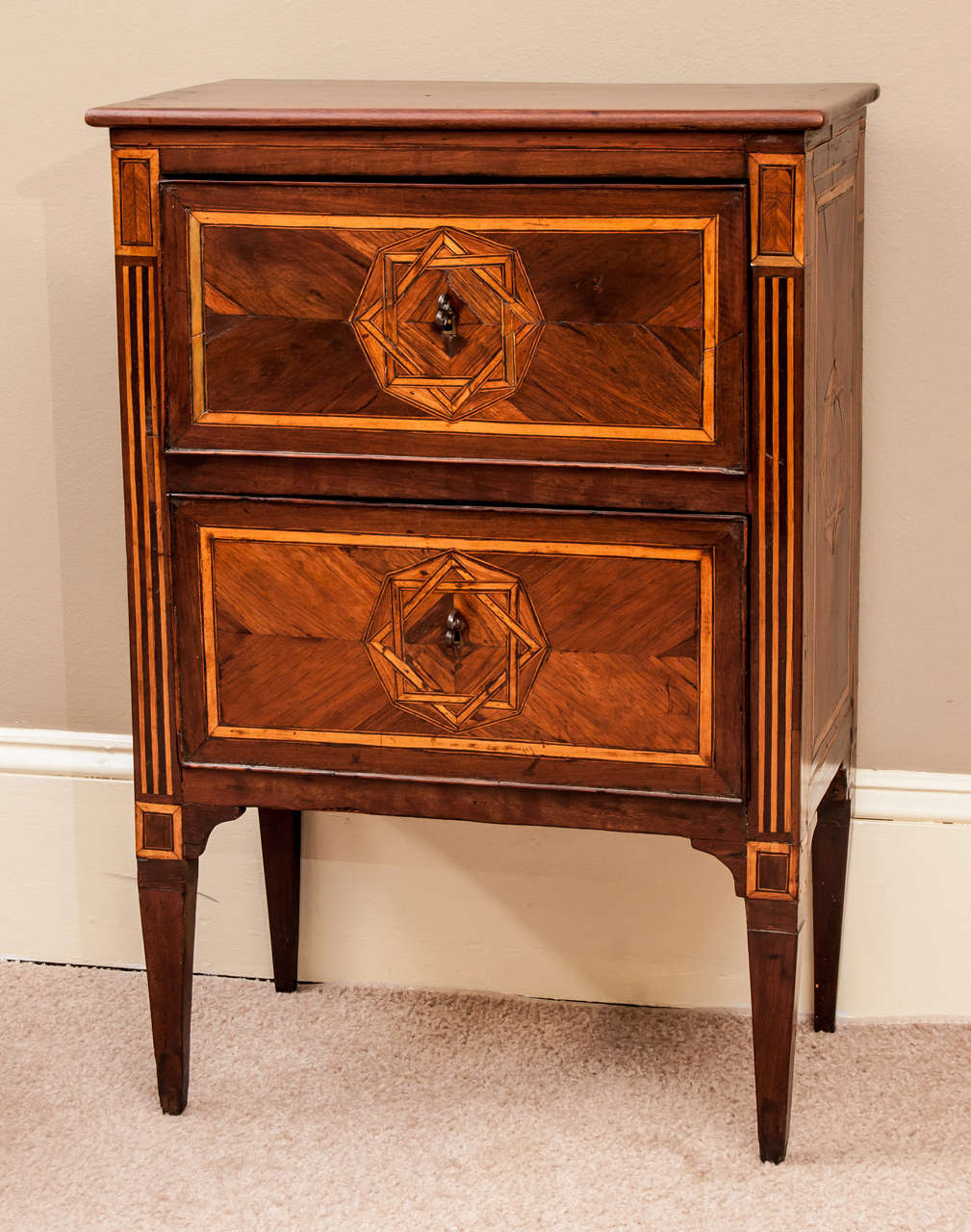 This commode has an inlay of the  eight pointed star on drawer fronts. Inlaid reeded stiles on front and inlay on sides. Original brass key pulls, restored old French polish, small size means it has a multitude of uses.