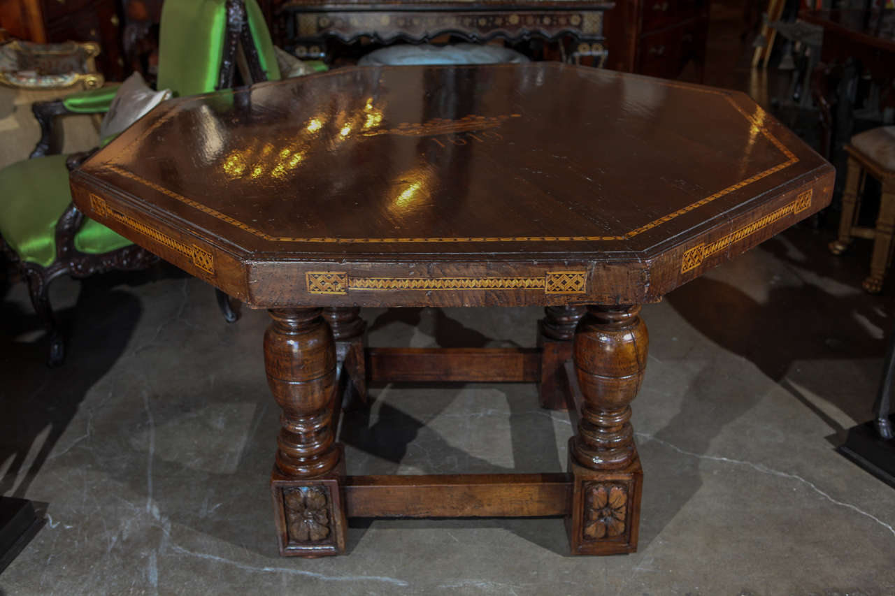 Stunning, grand, hand-carved, octagonal, Italian, walnut commemorative center table. The top featuring a marquetry, pearwood crown with the date 