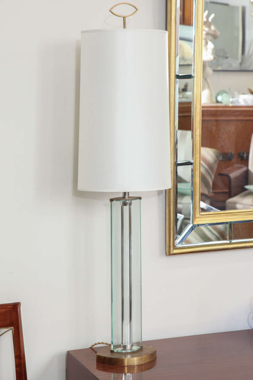 Stunning pair of tall table lamps designed by Roberto Giulio Rida, made in 2005 in Milan. Two cut and polished bent glass pieces make up a clean elliptic lamp with a beautiful finial.
 