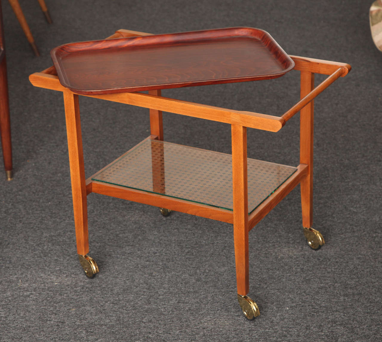 Bar/serving cart designed by Julius Jirasek, made in 1935 in Vienna by Hagenauer Werkstätte.
Light color wood. Glass on cain shelf with original tray marked Gerlinol Sol.-Ohligs.
Great modern form. Originally owned by Franz Hagenauer.
 