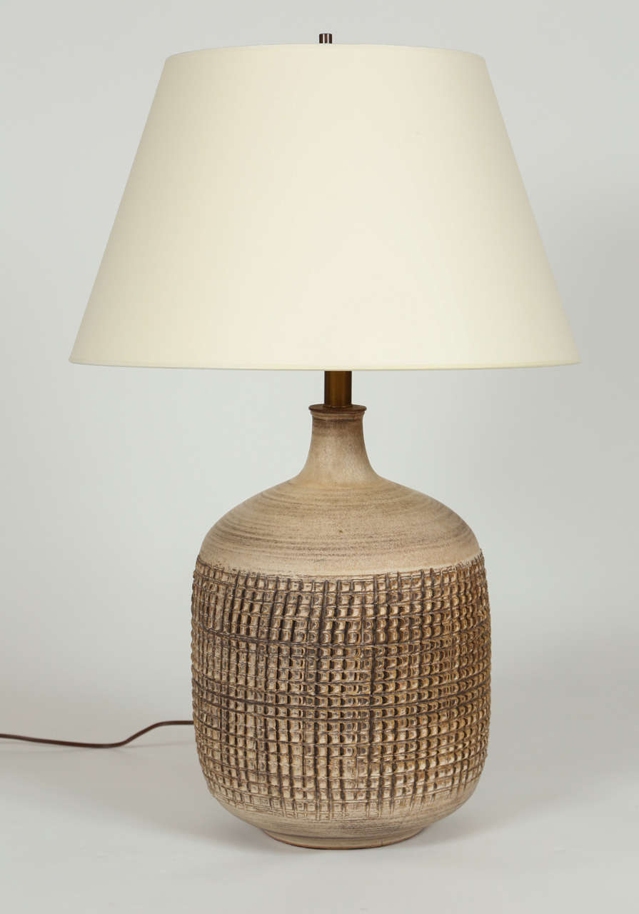 A pair of hand thrown Lee Rosen Design Technics Mid-Century Modern table lamps with a heavily textured embossed pattern. Signed with the Design Technics mark. Appears to be original wiring and sockets, which are fully functional.  Shades sold