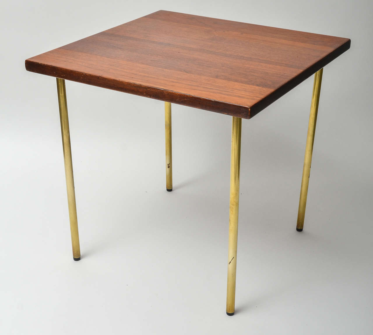 Square form, solid teak Danish side table with screw-in brass legs.
Manufactured by France & Son, this useful 